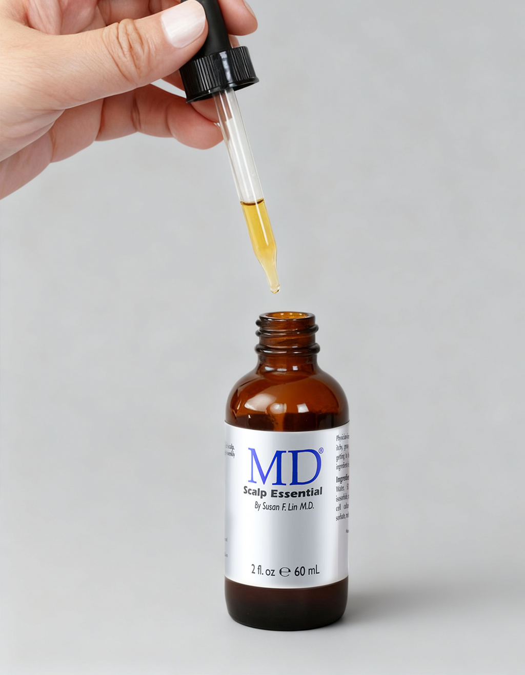 MD Scalp Essential dropper applicator dispensing the lightweight zero-grease serum