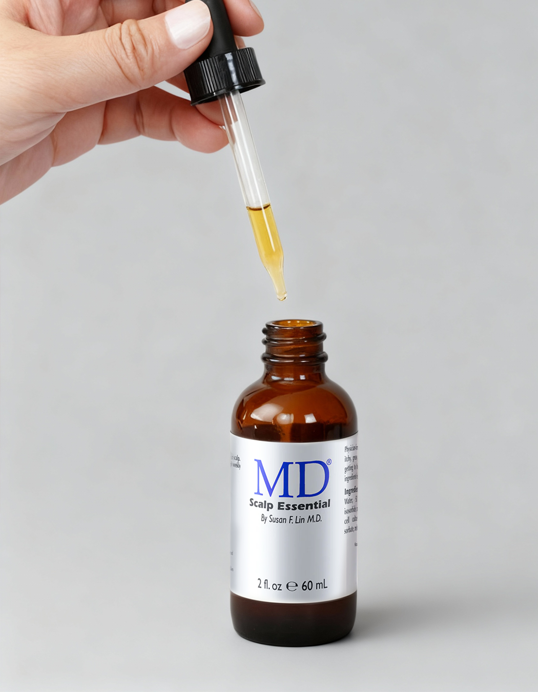 MD Scalp Essential dropper applicator dispensing the lightweight zero-grease serum