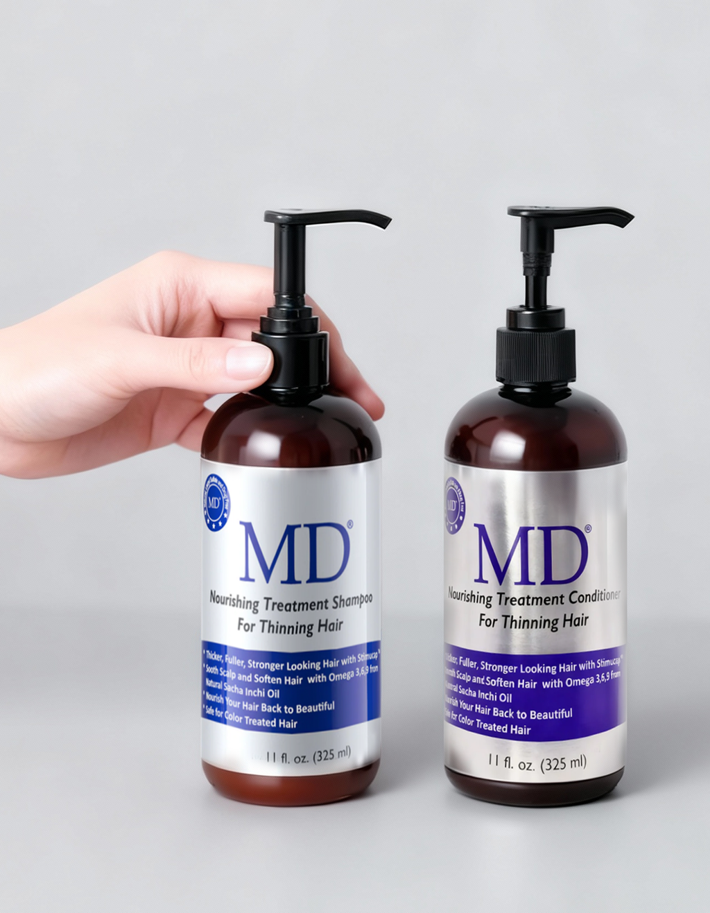 Hands holding the MD Revitalizing Shampoo and Conditioner bottles together