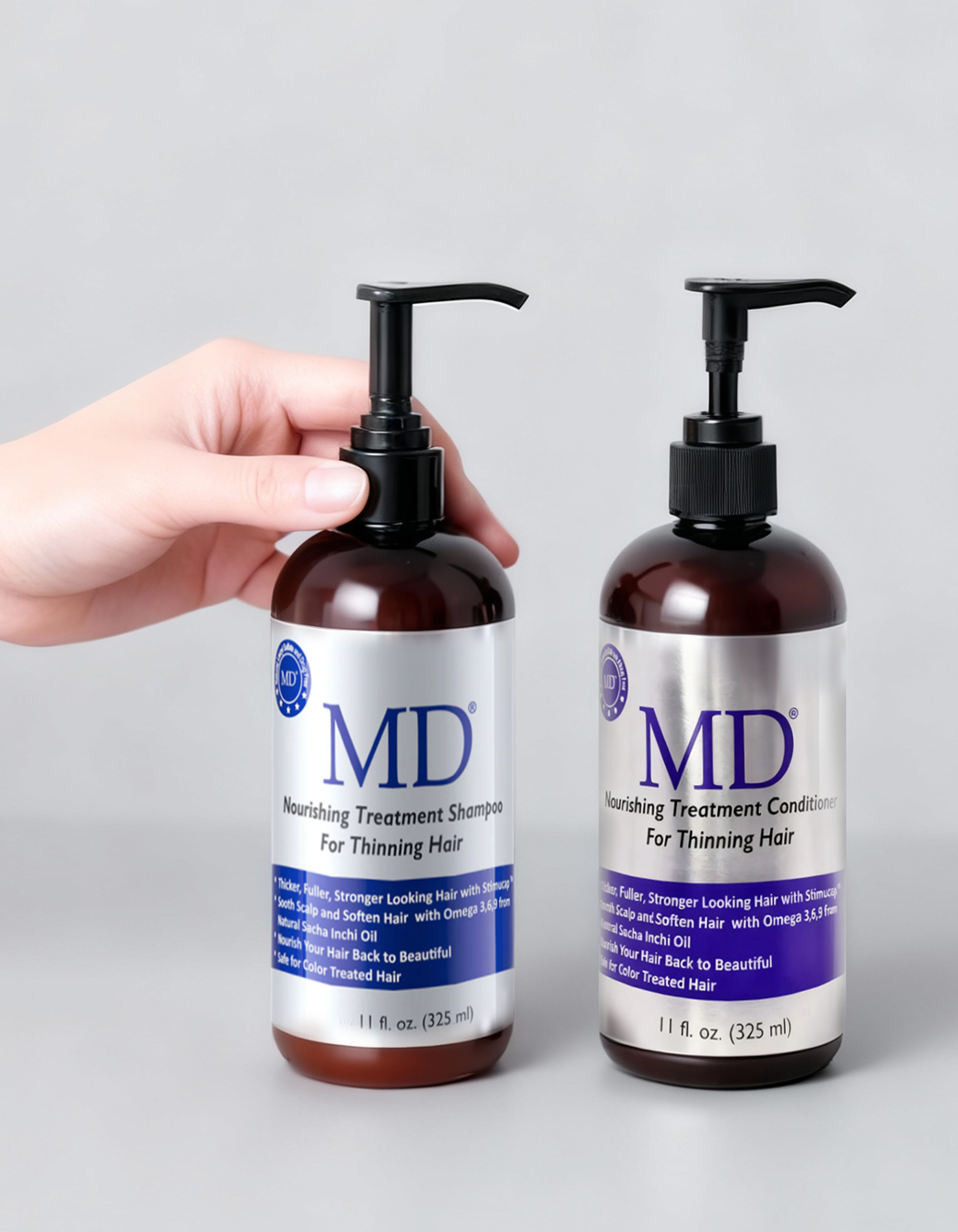 Hands holding the MD Revitalizing Shampoo and Conditioner bottles together